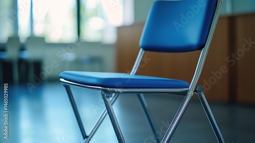 A compact folding office chair with a sturdy metal frame and cushioned seat for versatility.