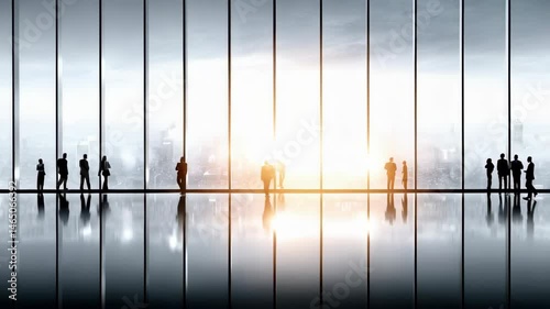 Group of diverse people standing together in front of a modern glass wall in an urban environment during daylight hours