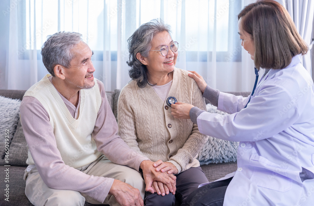 Fototapeta premium senior couple being examination from a doctor in uniform,using stethoscope listening on chest old woman,her husband holding hands to give encouragement