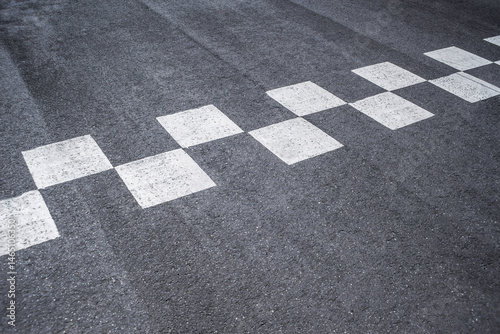 Close-up Starting and finishing grid asphalt. Checkered line on racing motorsport track.