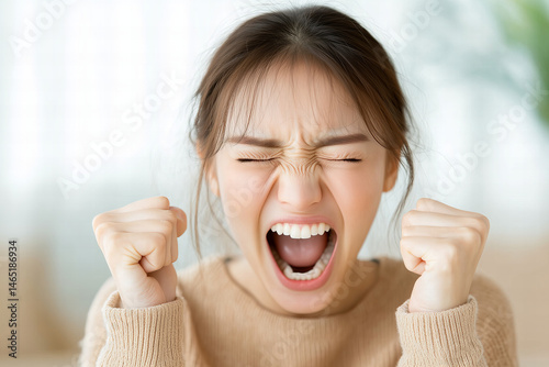Close Up Portrait Of An Upset Woman Screaming And Clenching Fists In Brown Sweater With Pixelation Effect