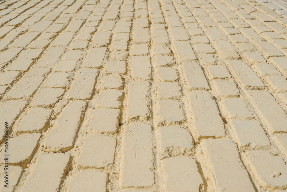 Fototapeta premium Closeup backgrounds texture of yellow beige painted retro brick wall.