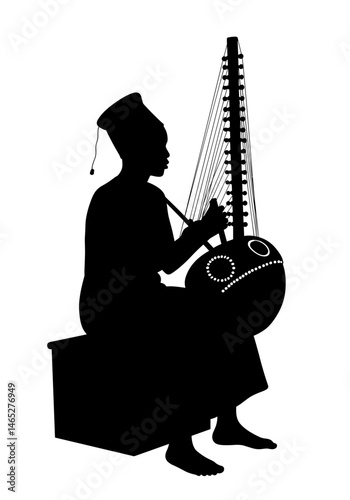 Silhouette musician playing kora instrument sitting