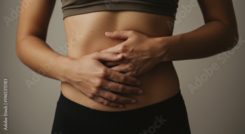 Woman Holding Her Abdomen in Discomfort