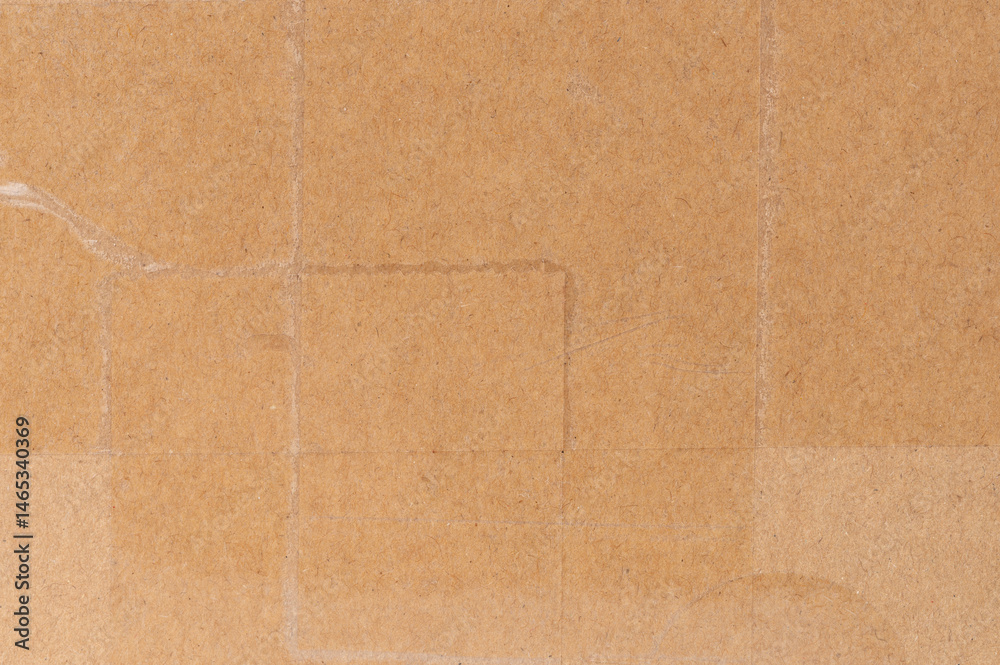 Brown cardboard box with different patches and textures in well-lit environment