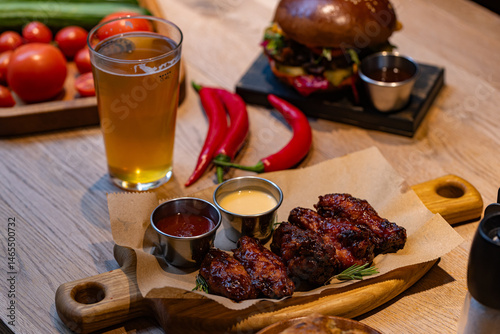 Closeup of chicken wings with dips served at restaurant