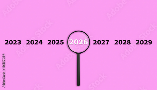 Lens, magnifying glass focusing on the year 2026 on a Pink background. Financial or stock market strategies and past and future events.