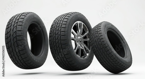 Three Vehicle Tires Float Against Clean White Studio Background Showcase Tread Depth And Alloy Wheel photo