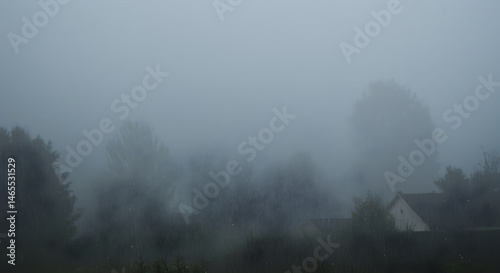 Ethereal Landscape A Dreamy View Of Trees And Houses Emerging From Dense Fog