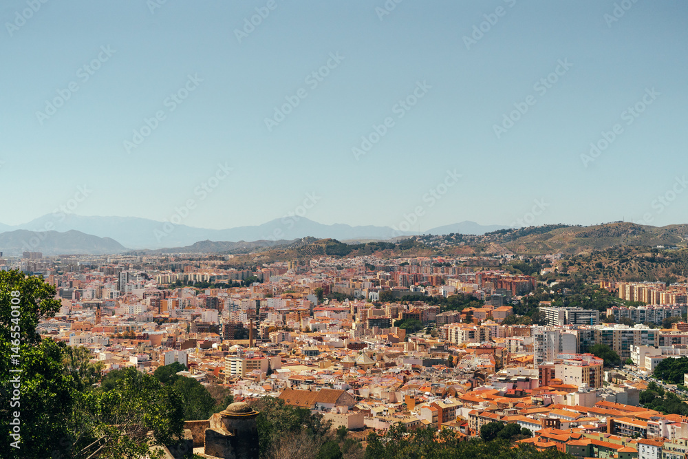 Obraz premium Scenic cityscape with mountains, capturing vibrant urban life and natural beauty.