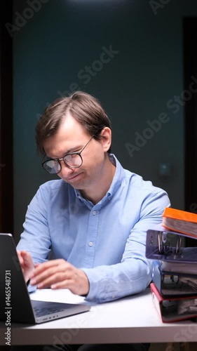 vertical video Stressed office worker suffering headache while working late at night