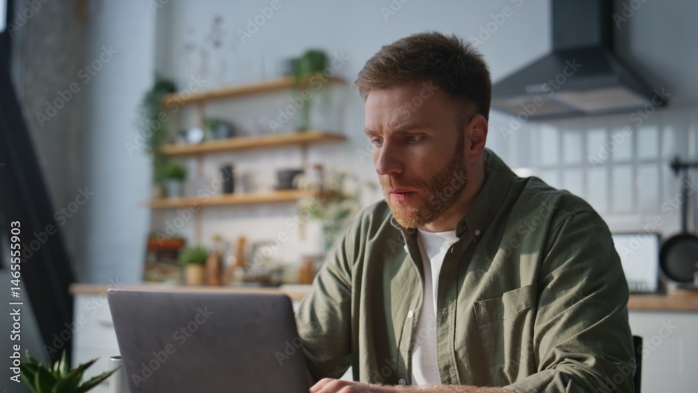 Serious businessman typing laptop at home office closeup. Busy manager working