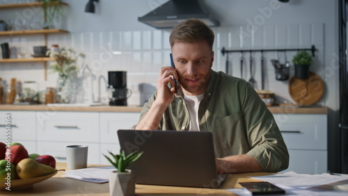 Obraz na płótnie Freelancer discussing work phone call looking laptop in home office closeup. w salonie