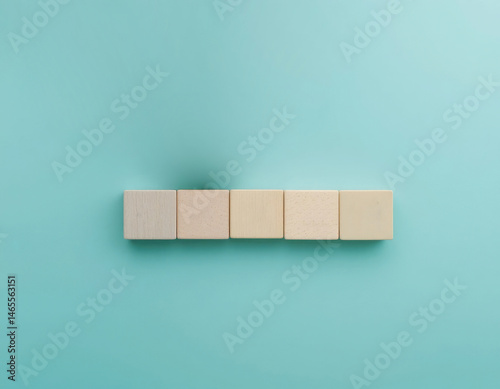 Obraz na płótnie Blank Wooden Blocks Arranged on Turquoise Background for Text or Icons w salonie