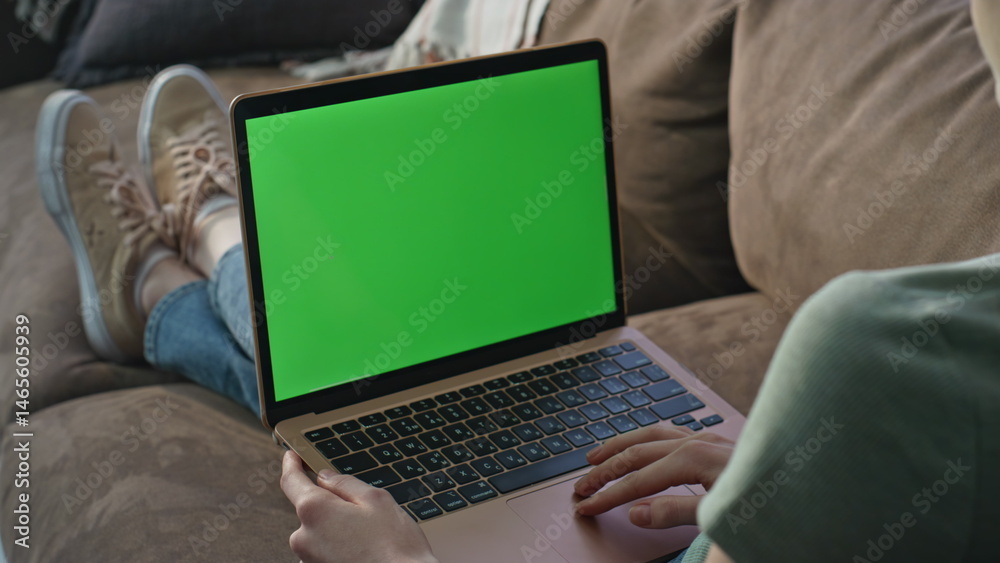 Student studying green screen laptop at living room couch closeup. Unknown woman