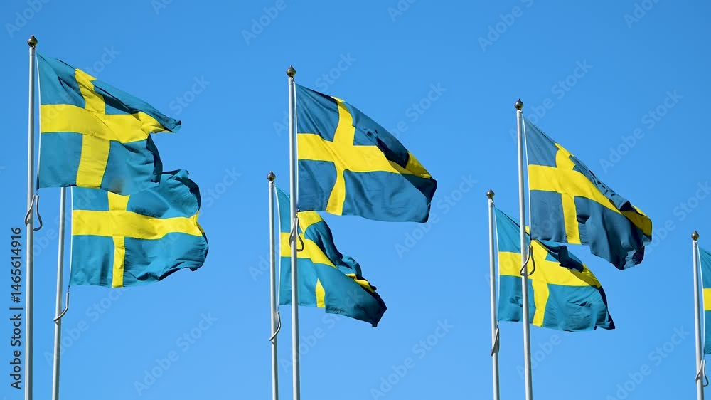 Swedish flags waving against clear blue sky