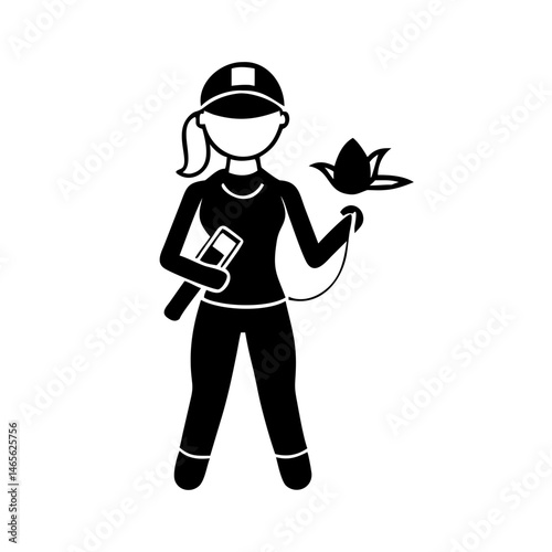 Silhouette of a woman with baseball cap holding a lotus flower