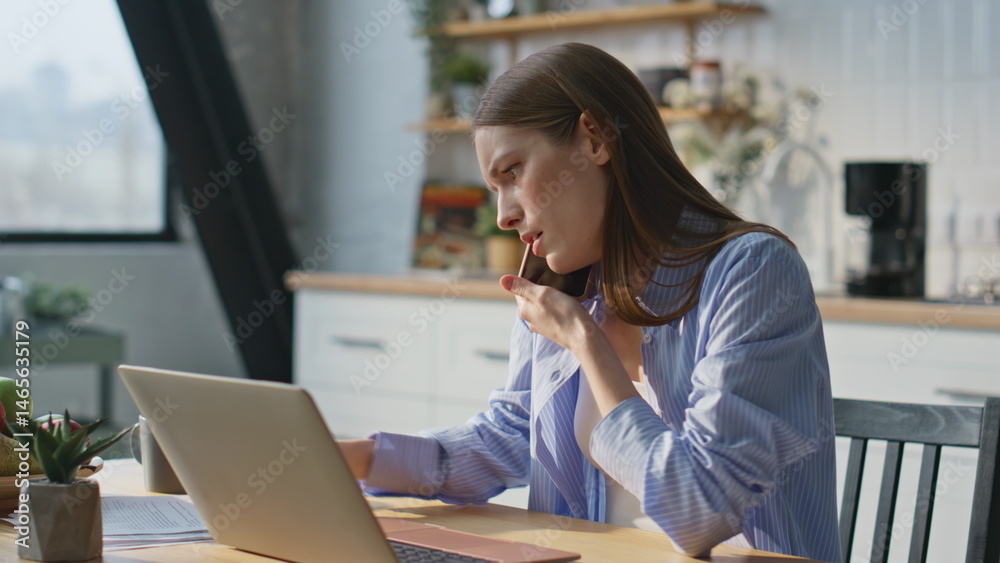 Busy entrepreneur talking cellphone working laptop at home office closeup.