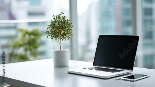 Wallpaper Mural A stylish office workspace with a laptop, phone, and plant, ready for productivity in a bright room. Torontodigital.ca