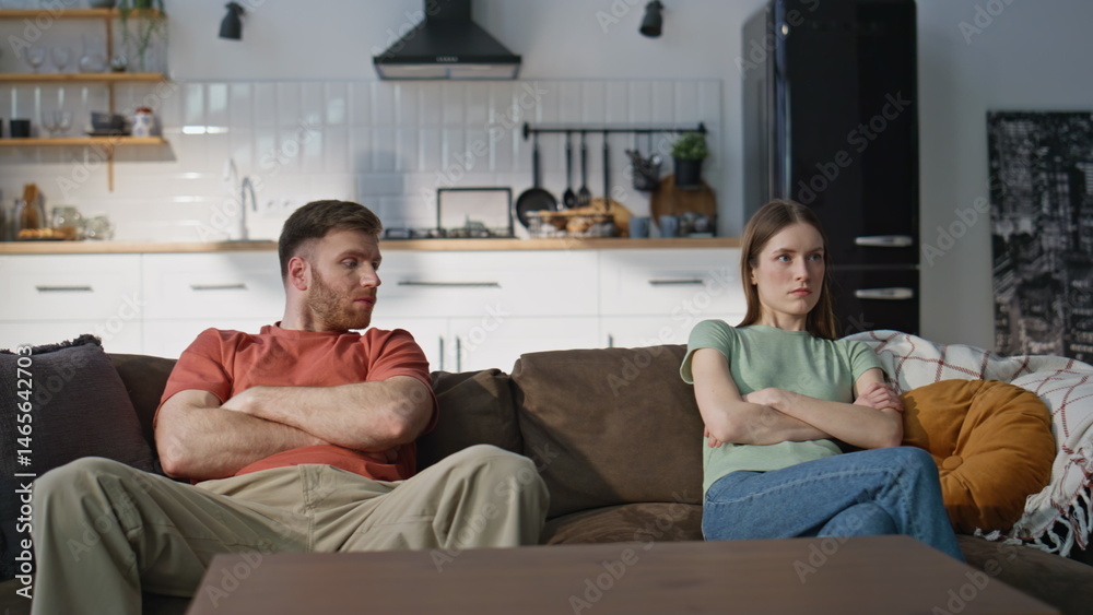 Unhappy couple quarrel sitting home couch showing disagreement. Marriage crisis