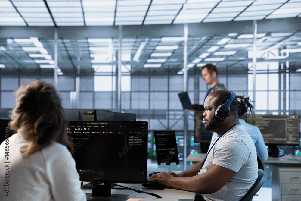 African american man in data center coordinating deployment of server architecture, improving data processing speed. Worker listening music in server farm, configuring and testing equipment