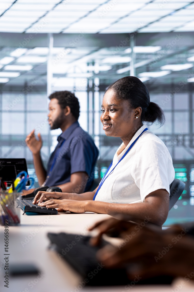 Cheerful engineer reconfiguring server farm to optimize it for data processing requirements of customers. Joyous woman working to ensure data center equipment operates efficiently