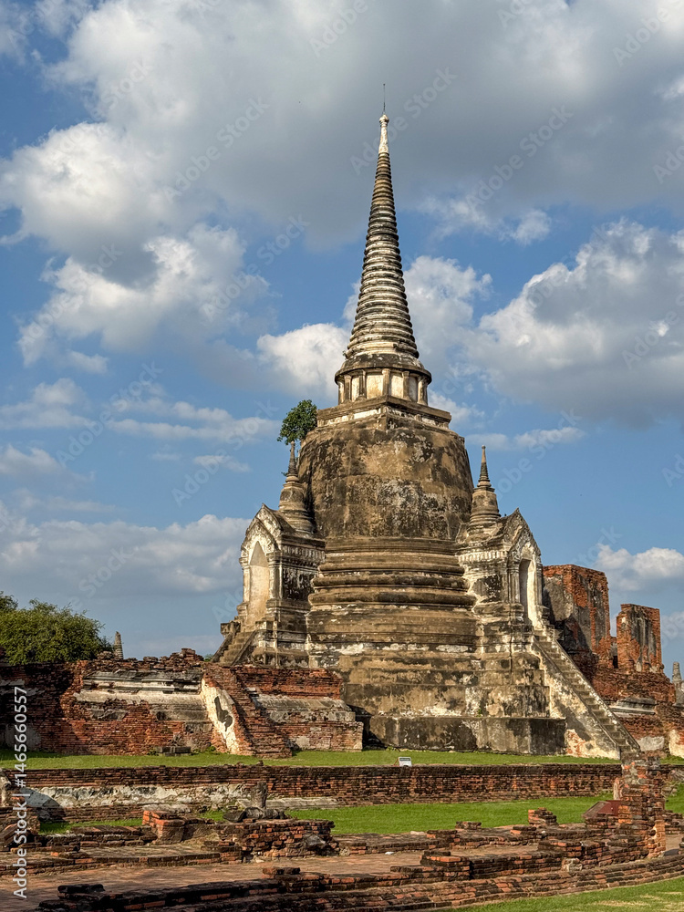 People visiting the famous Wat Maha That Buddhist temple landmark, peaceful sacred place of worship with ancient construction. Historical Thai heritage and culture, brick monument.
