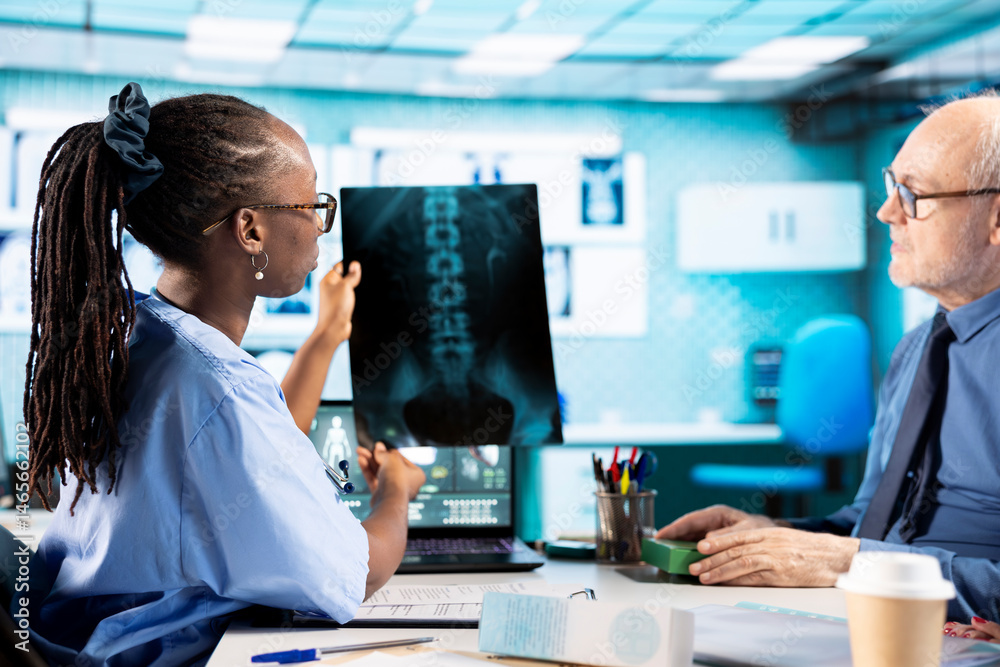Medical expert studying hospital records and x ray test results in cabinet, offering the right diagnosis for senior patient. Medic reviewing MRI scans and doing healthcare reports.