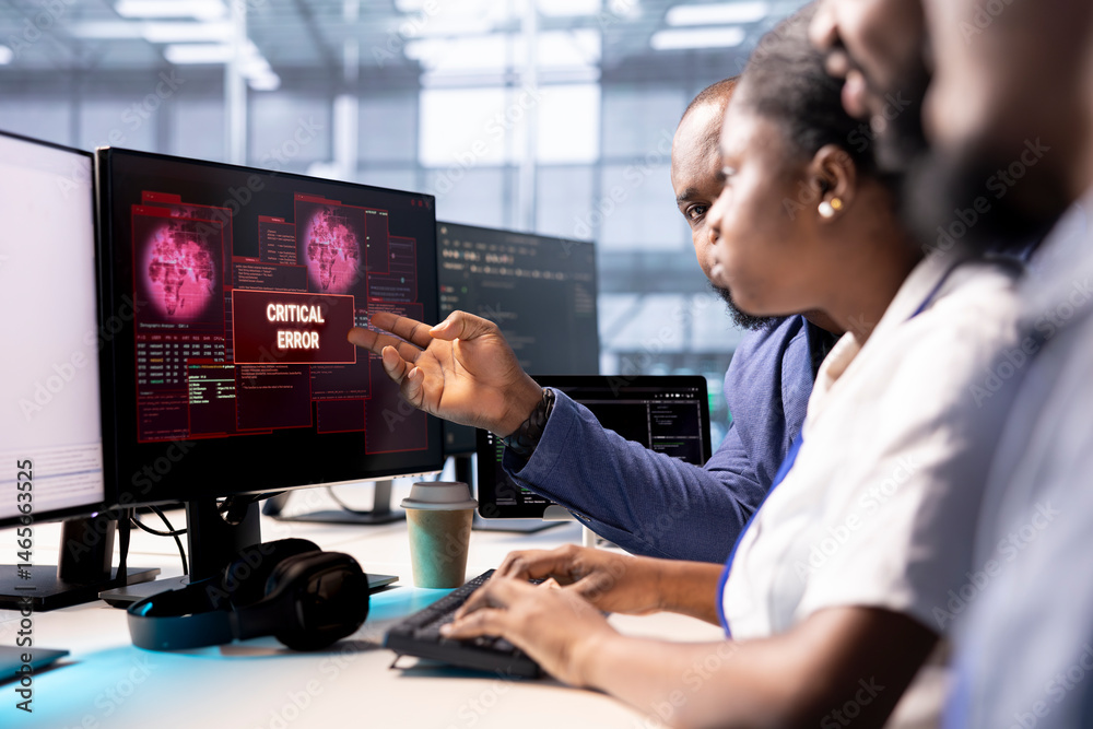 Cybersecurity coworkers monitoring security incidents affecting server hub network system, alerted by security breach alert, brainstorming ways to eliminate danger, protecting infrastructure