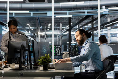 Obraz na płótnie Upset engineer in data center packing personal items at workstation after being replaced by AI. Technician removing belongings from server hub workplace desk, fired by artificial intelligence w salonie