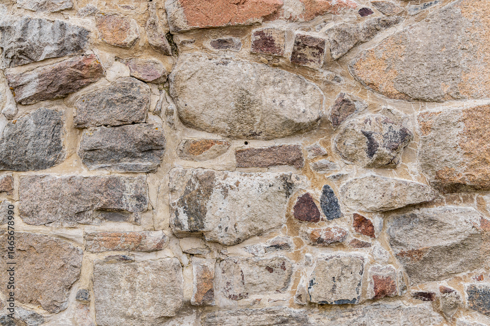Patterns in the stone wall of a historic fortress.
