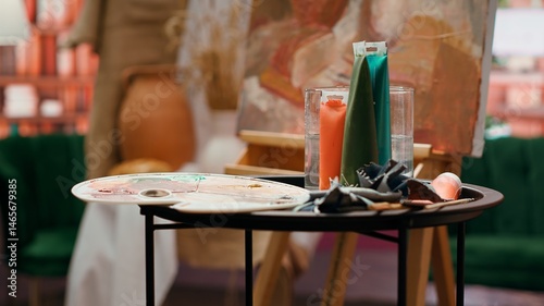 Painting inspiration supplies placed and ready to be painted on canvas, watercolor painting technique in modern fine art workshop. Empty creative atelier used in creating innovative artworks.