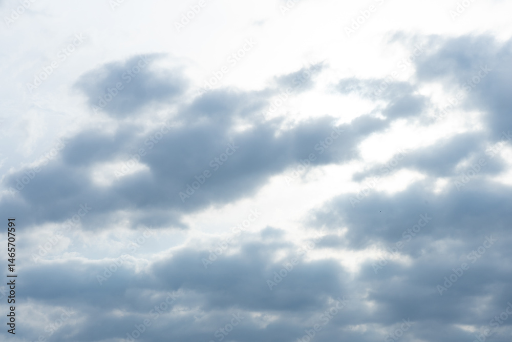 Fototapeta premium Cloudy sky with diffused sunlight shining through in the afternoon