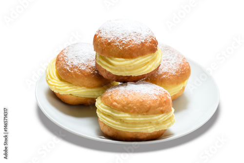 Obraz na płótnie Delicious bakery dreams with creamy filling and powdered sugar on a white plate