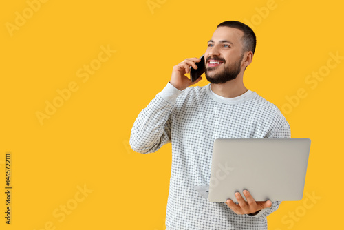 Young man with laptop talki...