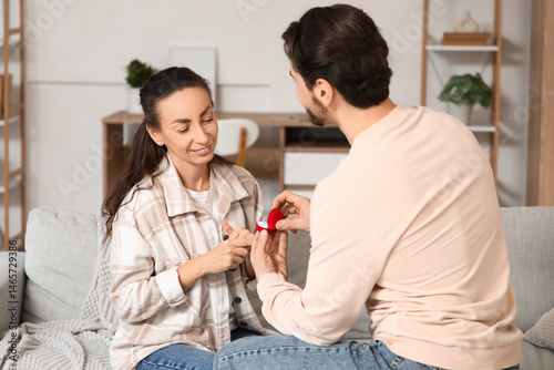 Young man proposing to his ...
