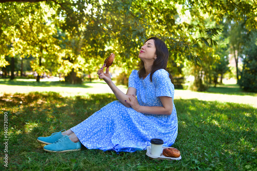 Happy Young Woman Enjoying Delicious Picnic Pastry Alone in Sunny Park