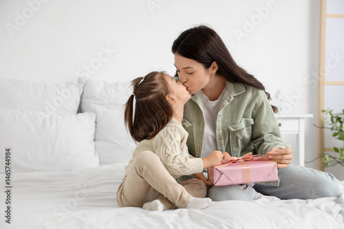 Young mother with gift box ...