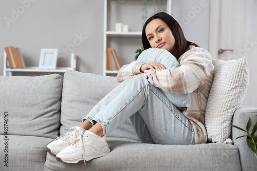 Worried woman sitting on so...