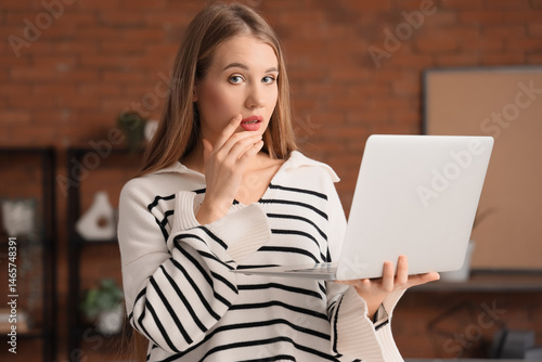 Worried young woman with la...