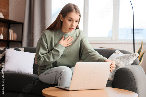Worried young woman with la...