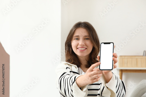 Young woman using blank mob...