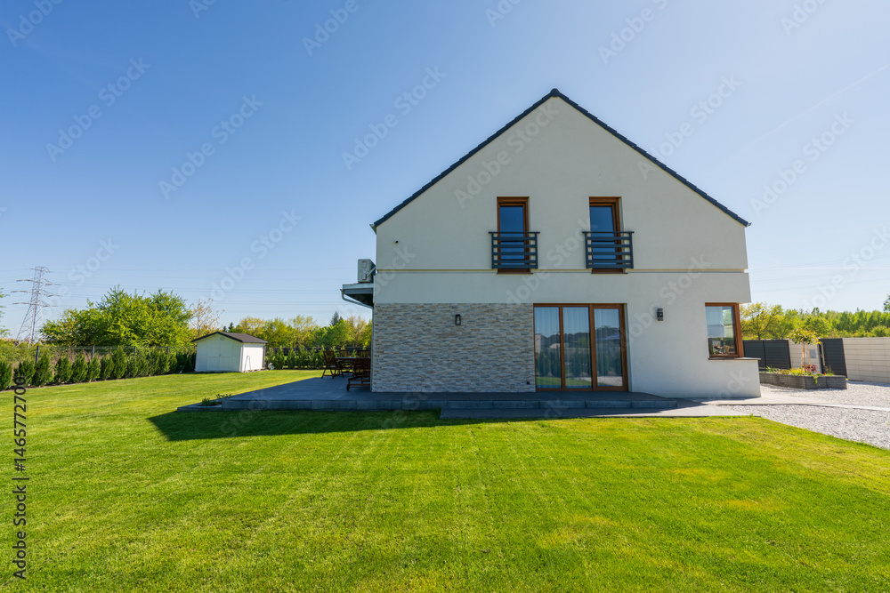Side view of new build house with freshly cut grass
