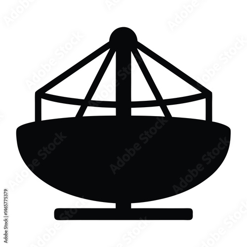 Silhouette of a swing ride, carousel, fairground attraction or playground equipment