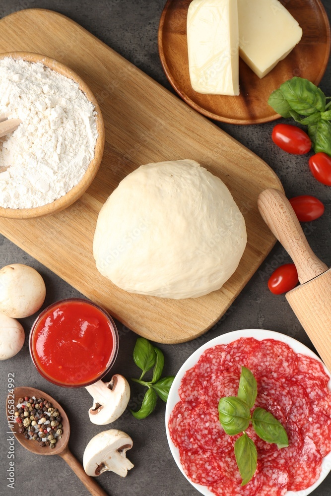 Fototapeta premium Making pizza. Different ingredients on gray textured table, flat lay