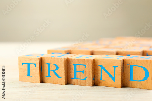 Word Trend made of wooden cubes with letters on table