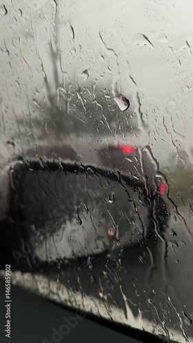 A car's rear view mirror is fogged up with rain. Barranquilla, Colombia