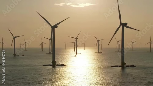 Golden Sunset Illuminating an Offshore Wind Turbine Farm in the Sea with Modern Renewable Energy Generation and Sustainable Power Production on the Horizon