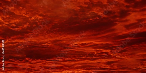 Abstract dark red background. Dramatic red sky. Red sunset with clouds. Fantastic sunset background with copy space for design. Halloween, armageddon, apocalypse, end of the world concept.
