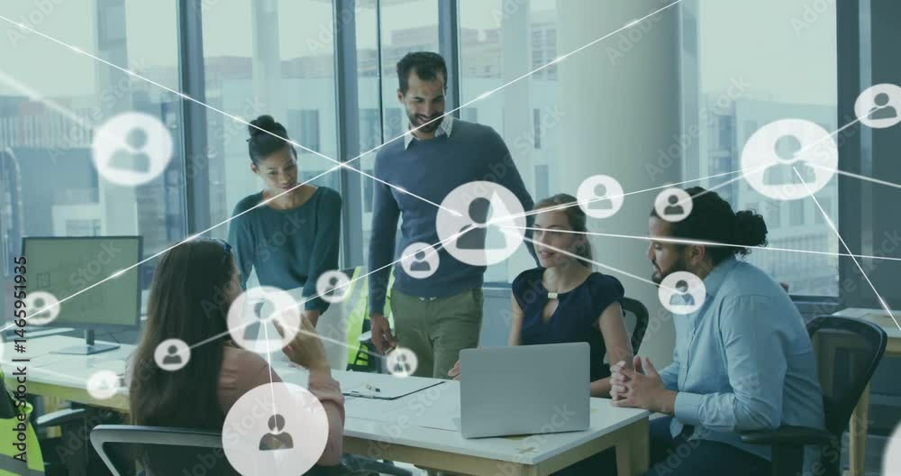 Team collaborating around business meeting table in office, overlaying user icons and network lines